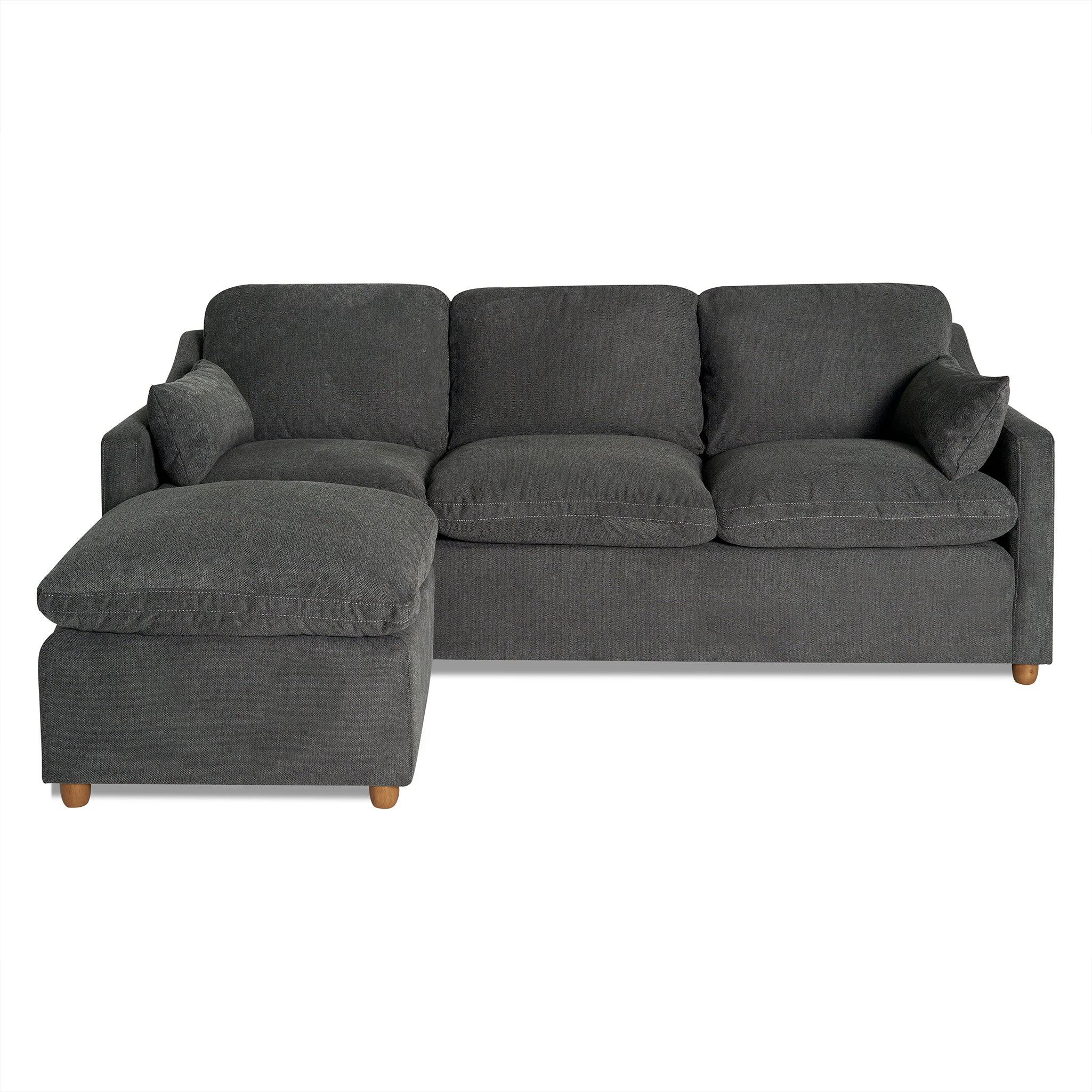 The My Cloud Slope Sofa is a dark gray L-shaped sectional with three cushions, a left chaise, wooden legs, and matching armrest cushions. It features machine-washable covers and offers a modern, plush appearance.