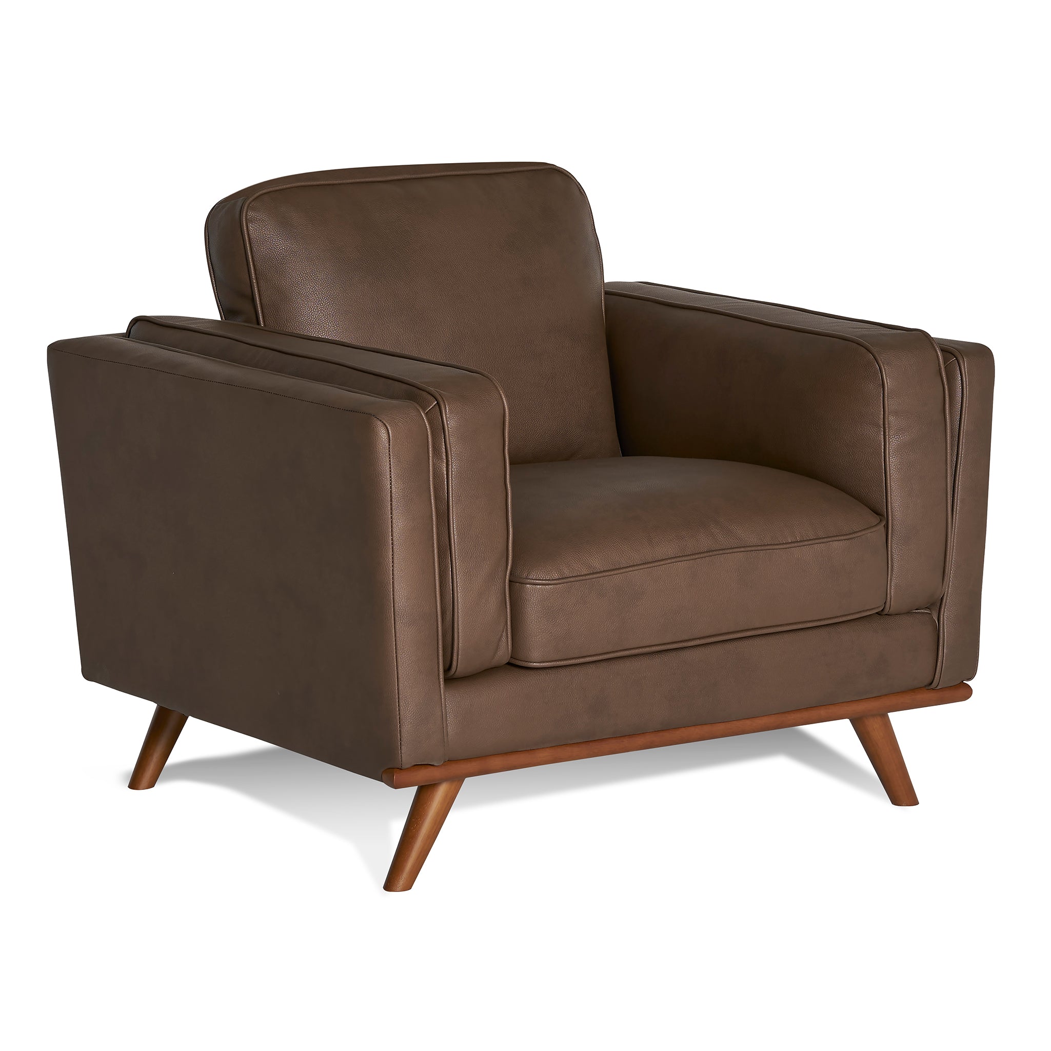 The Maddox Chair, with a mid-century modern design, features plush cushions, clean lines, padded armrests, and angled wooden legs in brown leather, set against a plain white background.