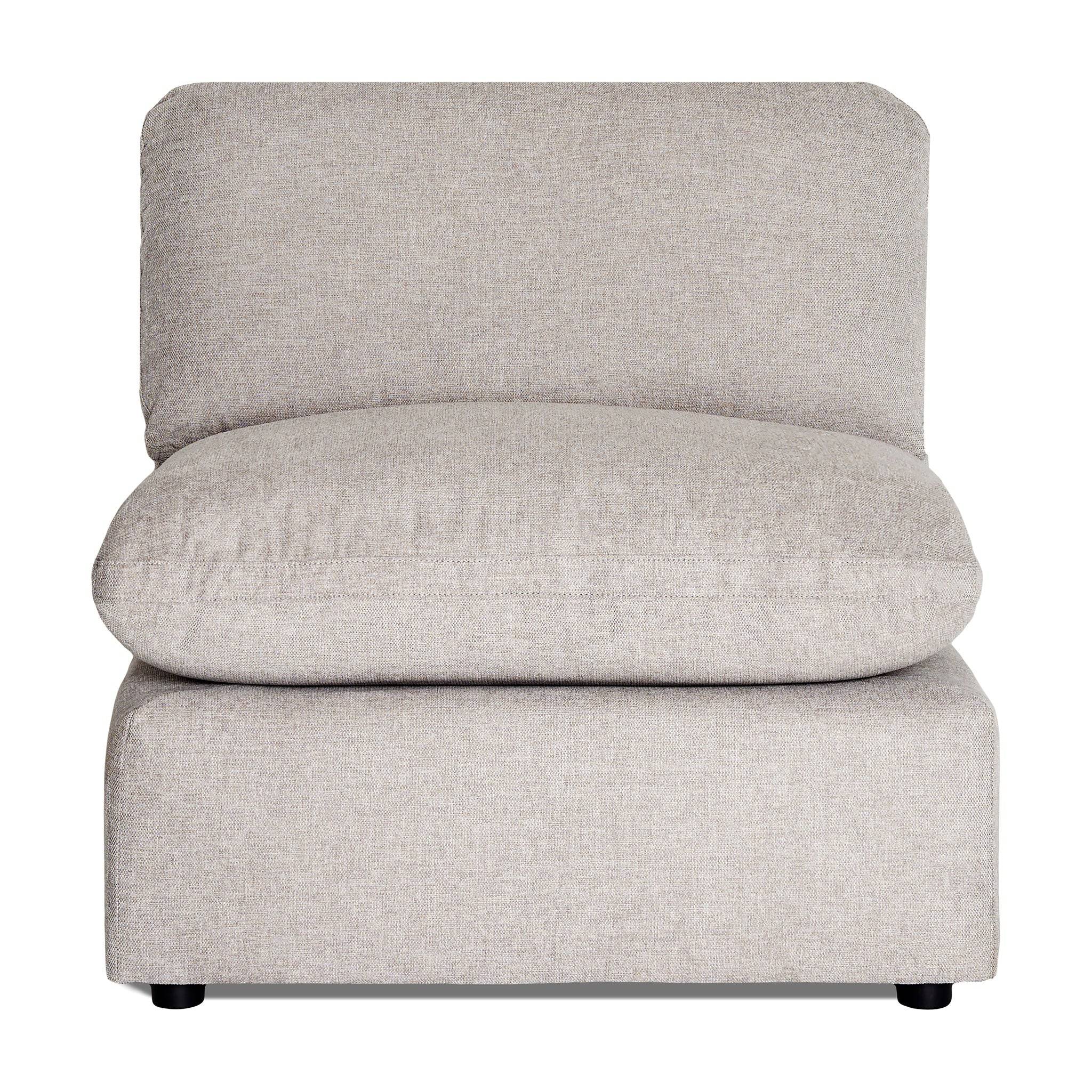 The My Cloud Slope Armless is a simple gray armchair with a thick cushioned seat and backrest. It features a minimalist design that complements versatile sectionals, lacks visible armrests, and sits on small black legs, offering a modern and comfortable look.