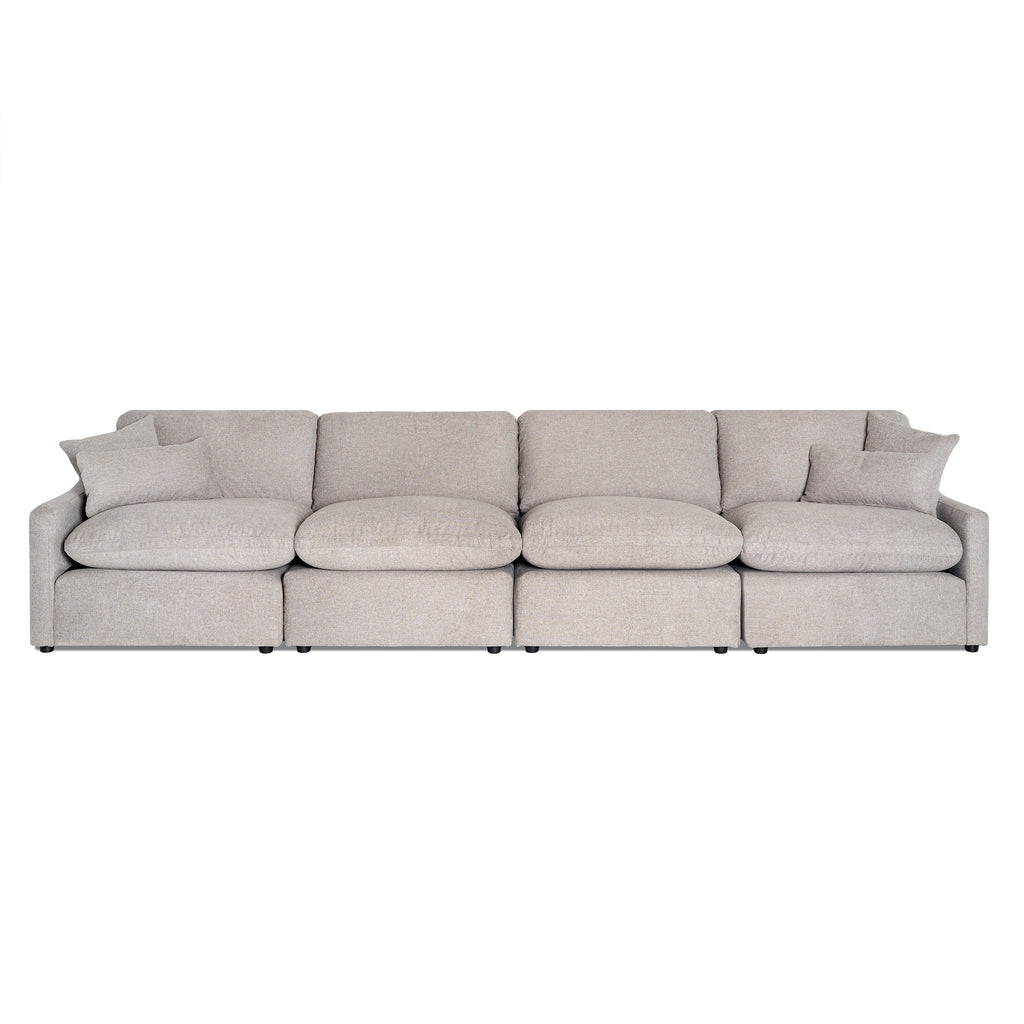 The My Cloud Slope 4 Piece Straight is a beige sectional sofa with a modern, minimalist design featuring four seats and matching cushions. Its soft fabric upholstery and rounded edges ensure exceptional comfort for any contemporary living space.