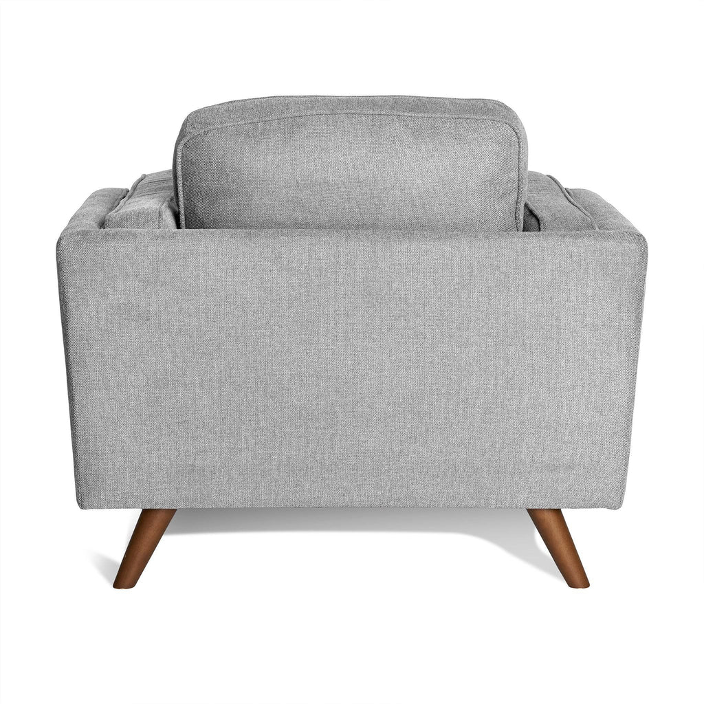 The Maddox Chair is a light gray fabric armchair showcasing a clean, mid-century modern design from the back. It features tapered wooden legs and plush backrest cushions, offering a minimalist yet elegant look akin to the Maddox Sofa Set.