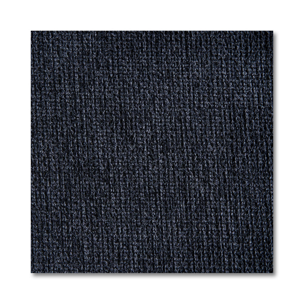 Close-up of a dark blue textured carpet tile with vertical ribbed patterns, reminiscent of the design in My Cloud 4 Piece Straight. The square tile, resembling machine-washable fabric sections, stands out against a white background, highlighting its detailed fibers.