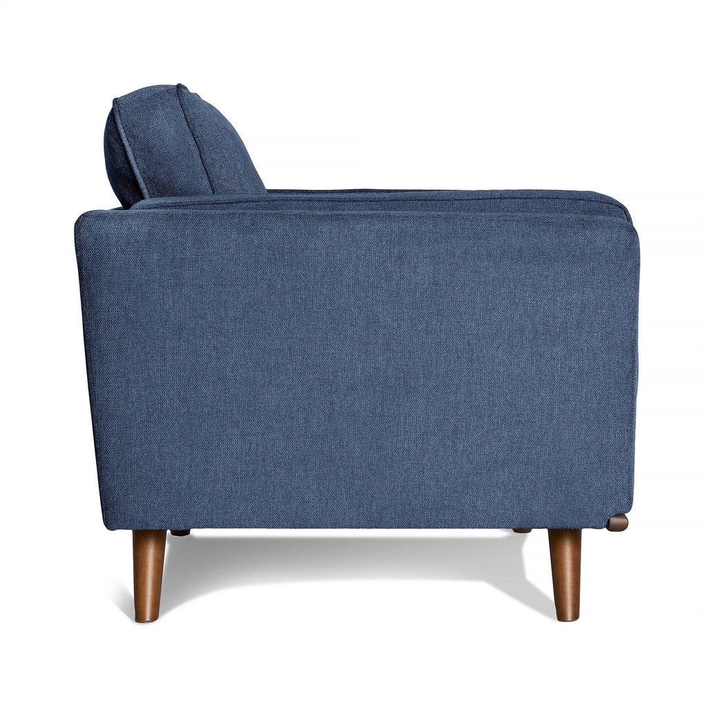 Side view of the Maddox Chair, a modern blue fabric armchair featuring a high backrest, rounded wooden legs, and a minimalist design reminiscent of mid-century modern style with clean lines for comfort.