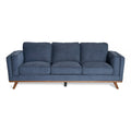 The Maddox Sofa is a blue three-seater with a mid-century modern design, featuring plush back cushions, slightly angled wooden legs, and a wooden frame base. Its clean, minimalist appearance makes it ideal for contemporary living spaces.