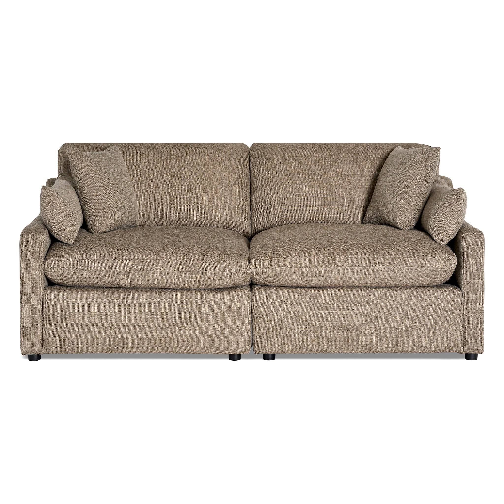 The My Cloud / Slope Arm is a tan, two-seater sofa with puffy cushions and rectangular armrests. It features machine-washable covers and comes with two matching throw pillows on each side, all set against a plain white background.