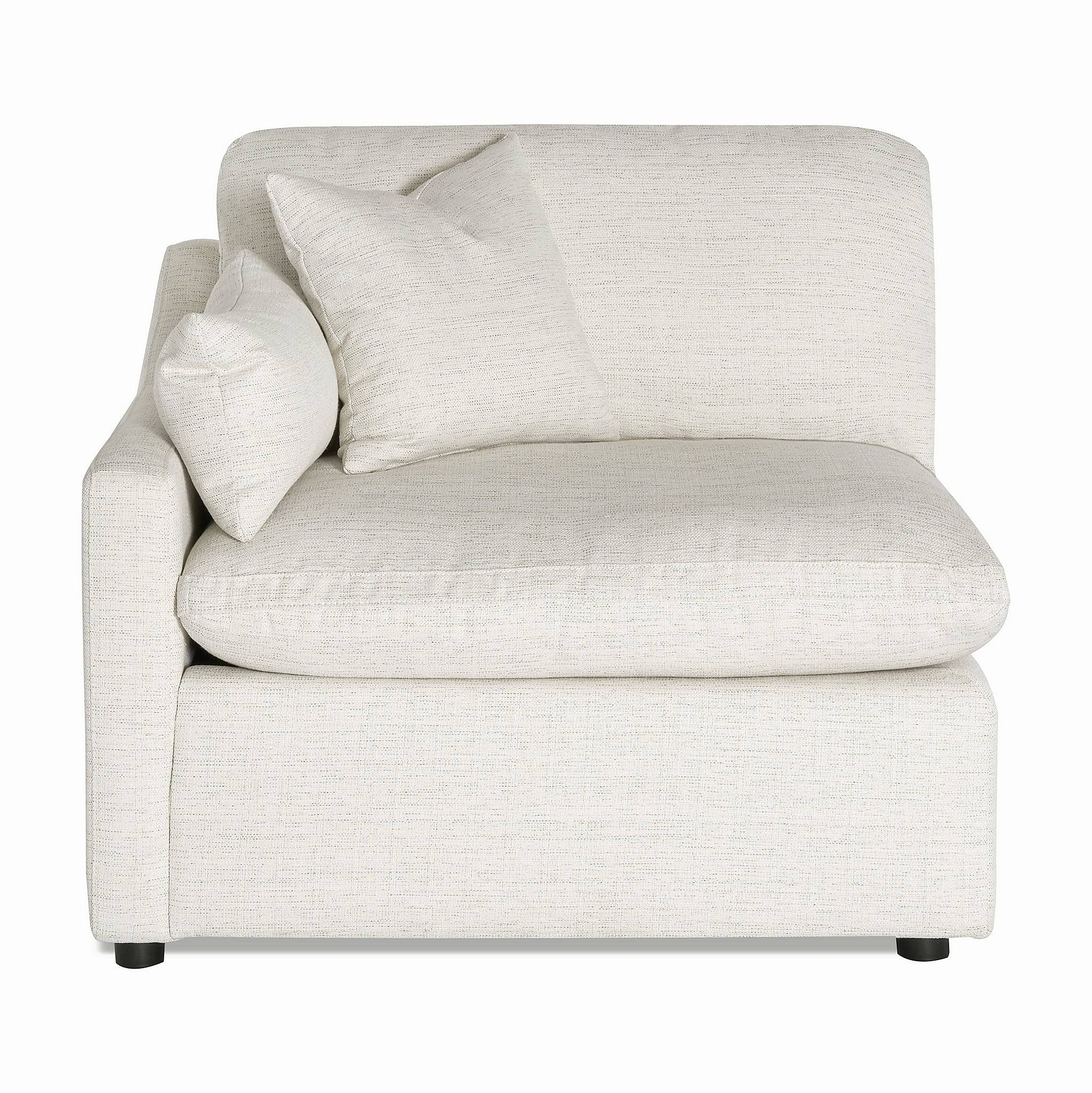 The My Cloud Slope Left Arm, a cozy cream-colored upholstered armchair with two square pillows, complements any living space. It boasts a modern design, slightly curved back, and short black legs, making it ideal as a modular component for versatile arrangements.