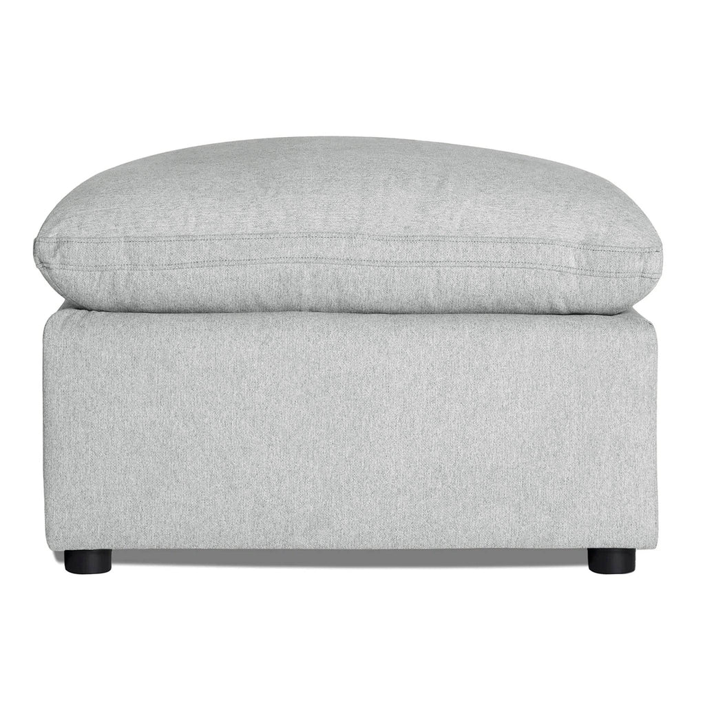 Discover the My Cloud 30 Ottoman, featuring light gray upholstery, a rectangular base, and cushioned top. It rests on four small round black legs, offering style and comfort for any space with customizable options.