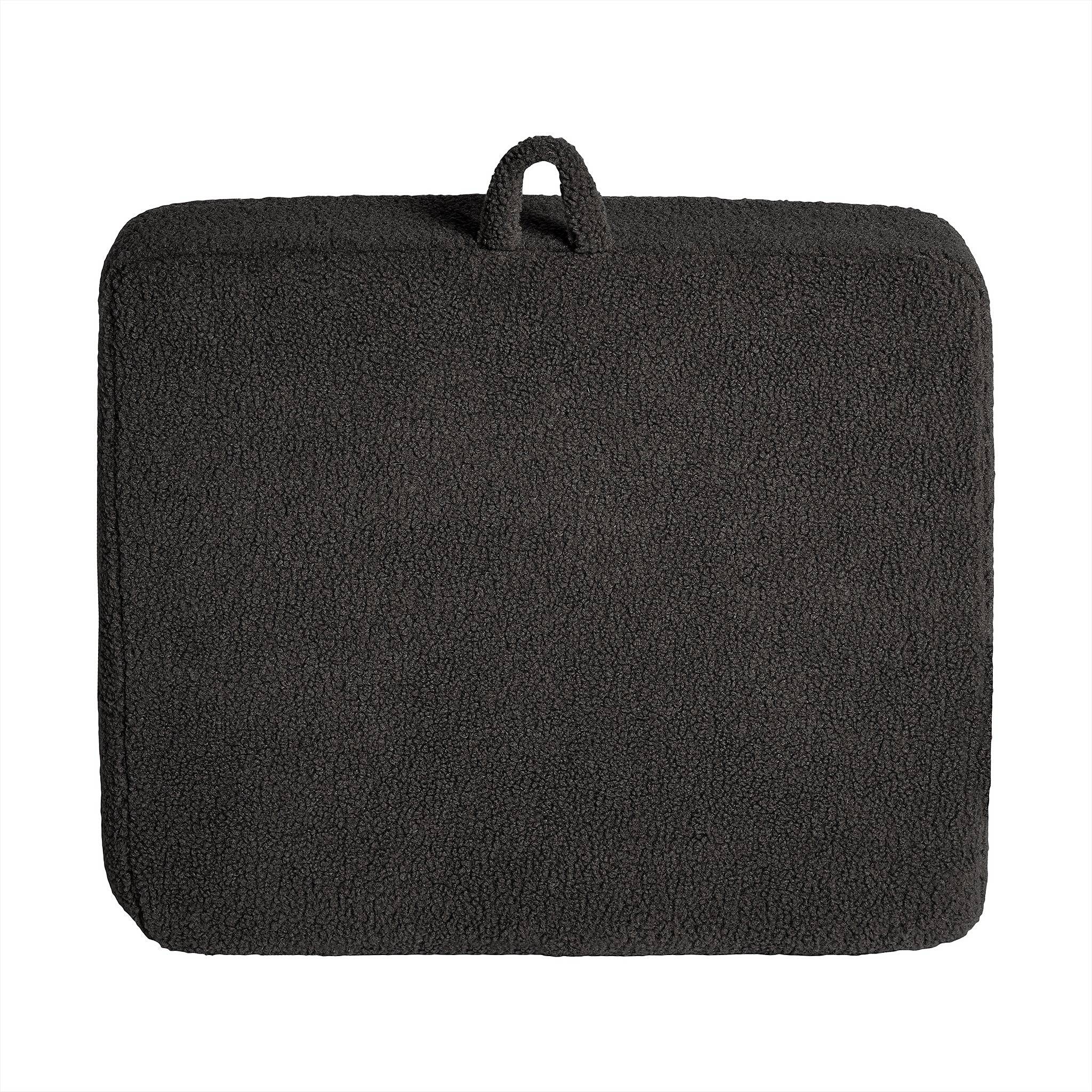 A rectangular, textured dark gray cushion with rounded edges and top loop for carrying or hanging is crafted from soft Sherpa fabric, boasting a fleece-like surface for added comfort. It perfectly complements the My Cloud Kidz Chair to create a cozy and inviting space.