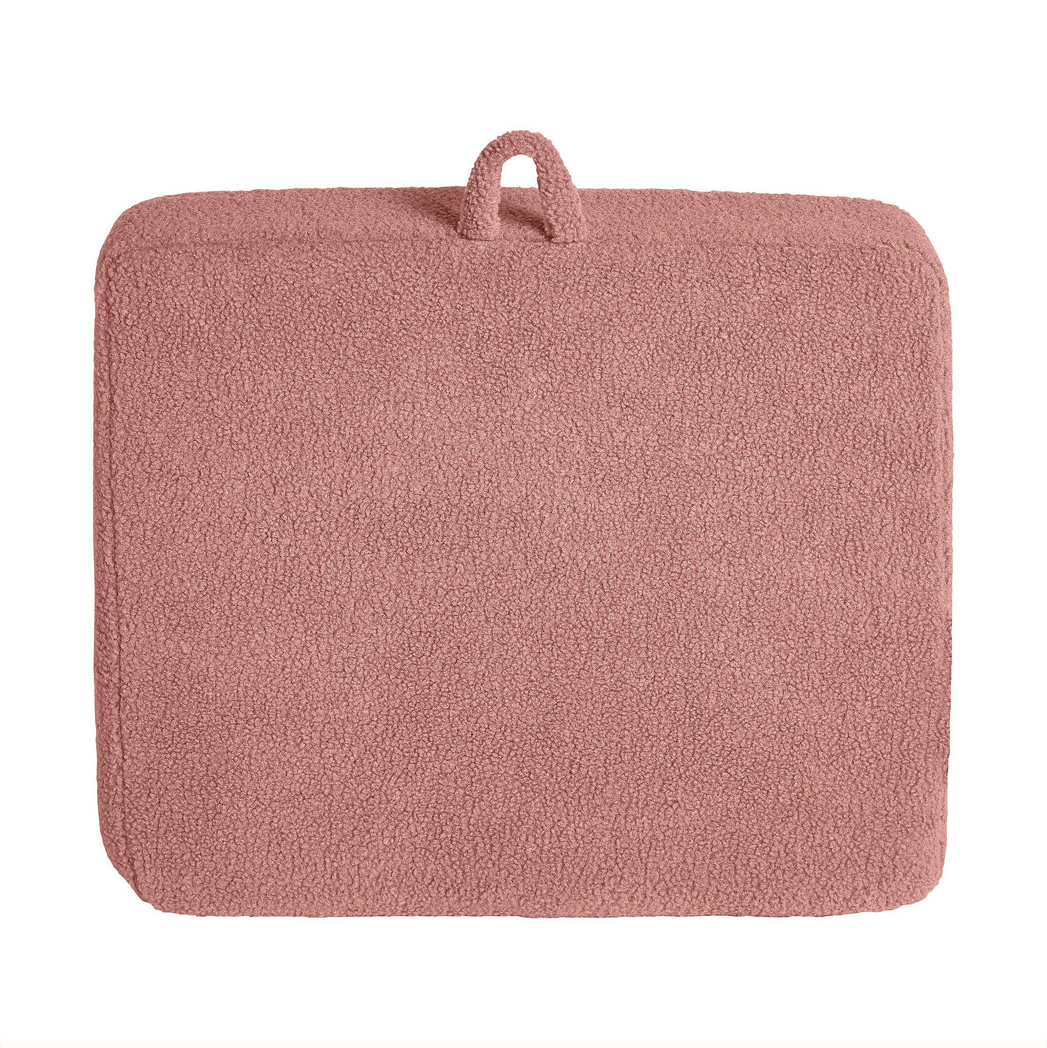A soft pink rectangular bath mat with a plush Sherpa fabric surface and a small fabric loop enhances modern minimalism, pairing stylishly with the customizable My Cloud Kidz Chair.