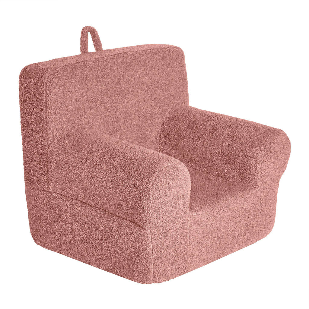 Introducing the My Cloud Kidz Chair: a cozy, plush pink armchair for kids, made with soft Sherpa fabric. It features a simple design with a rounded back, armrests, and a convenient fabric loop on the back for easy carrying—perfect for young adventurers on the move.
