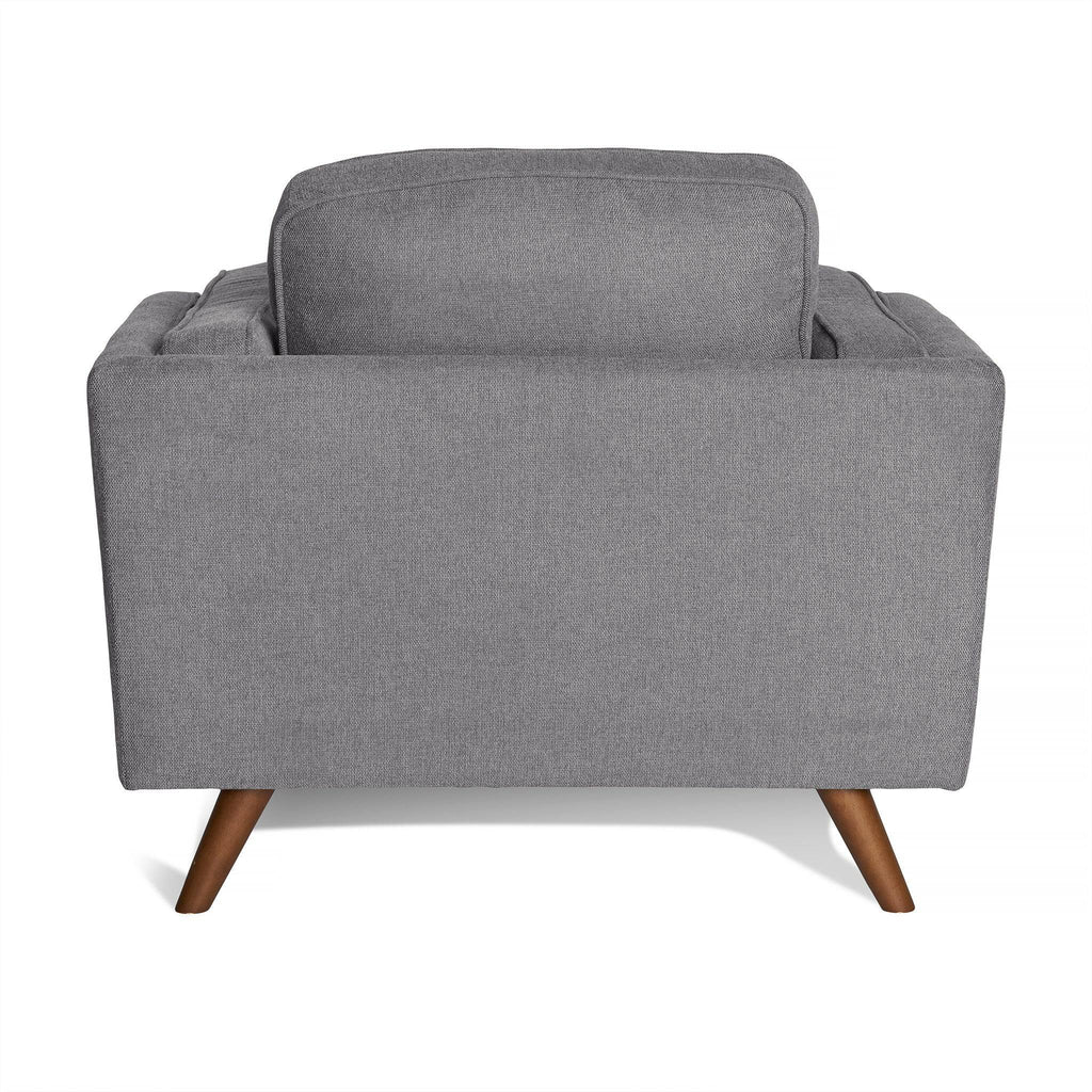 Back view of the Maddox Chair, a gray fabric-upholstered, mid-century modern armchair featuring wooden legs and plush cushions, shown against a white background.